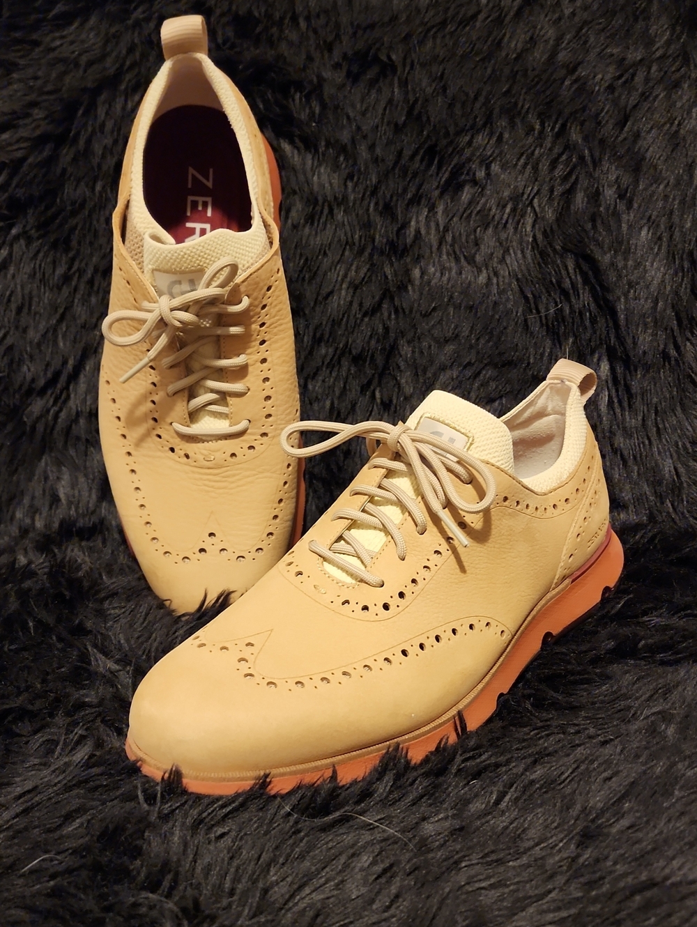 Cole Haan Beige Wingtip Oxfords with Orange Soles.  Runs big.